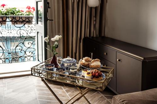 a tray of food on a table in a living room at 1926 La Galerie Boutique Art Suites in Valletta
