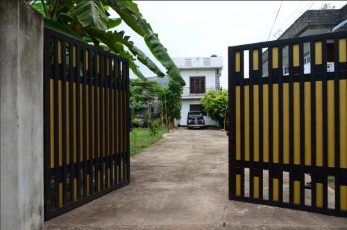 a pair of gates in front of a house at Abbi Holidays - Private Apartment Negombo in Negombo