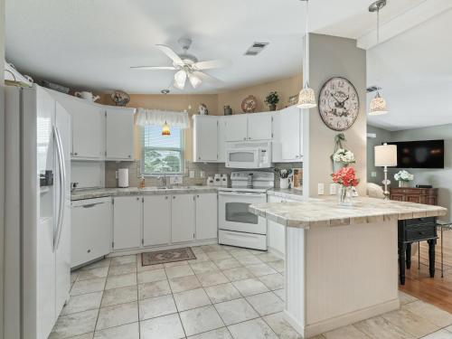 a kitchen with white cabinets and a large island at 1640 Z1 VILLAGE OF COUNTRY CLUB HILLS by REMAX Premier in The Villages