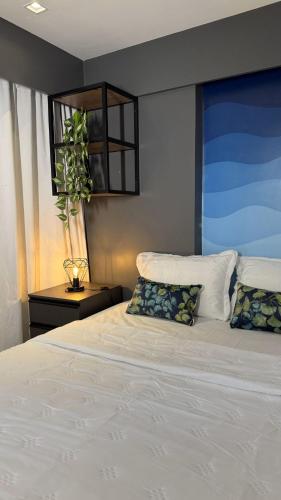 a bedroom with a large white bed with two pillows at Wanderlust Hostel in Maceió