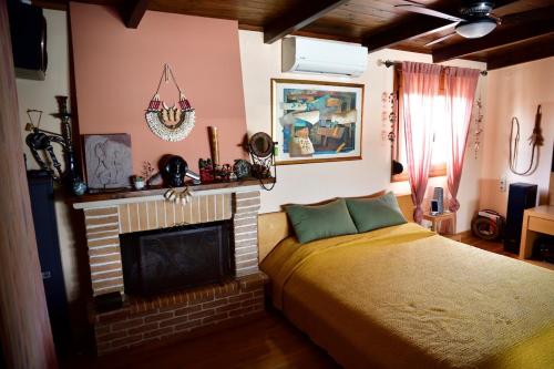 a bedroom with a bed and a fireplace at Panoramic deluxe penthouse in Thérissos