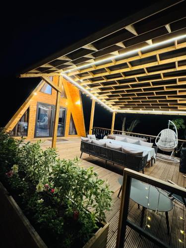 a deck with a couple of beds and tables on it at Suntau in Almaty
