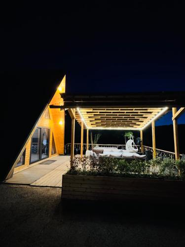 a house with a white tub on a deck at night at Suntau in Almaty
