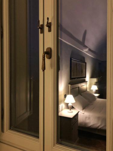 a bedroom with a bed and two lamps and a window at Palazzo Contelori in Terni