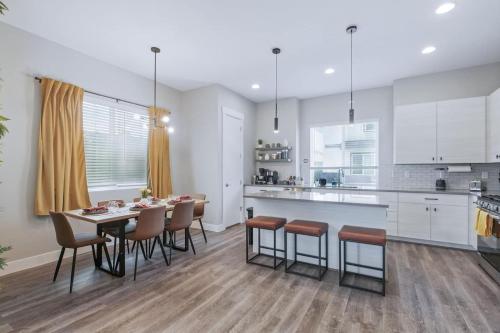 a kitchen and dining room with a table and chairs at 3br W King Bed, Sauna, Parking-6 Min To Olde Town in Arvada