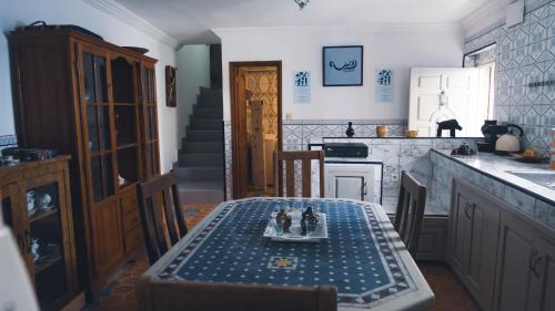 a dining room with a table and a kitchen at Roudania Tamraght Ocean View - Private Rooms And Hostel Vibes in Tamraght Ouzdar