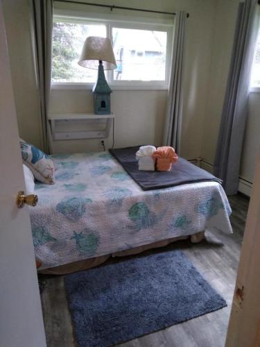 a small bedroom with a bed with a window at High Grade - Affordable, Near Mendenhall Glacier, Trails, and Conveniences -DISCOUNT ON TOURS! in Mendenhaven