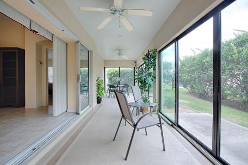 a room with glass doors and a chair on a porch at 1987 Z3a Village of Pennecamp by REMAX Premier in The Villages