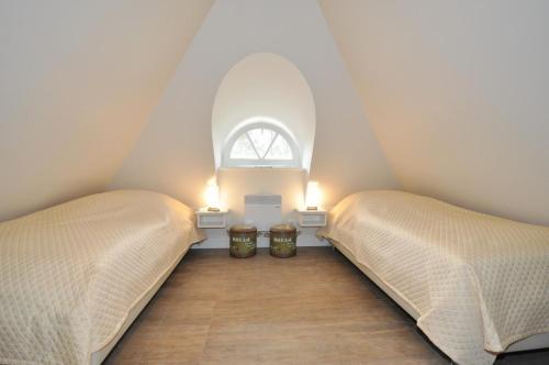 Ένα ή περισσότερα κρεβάτια σε δωμάτιο στο Doppelhaushälfte Düne & Reet