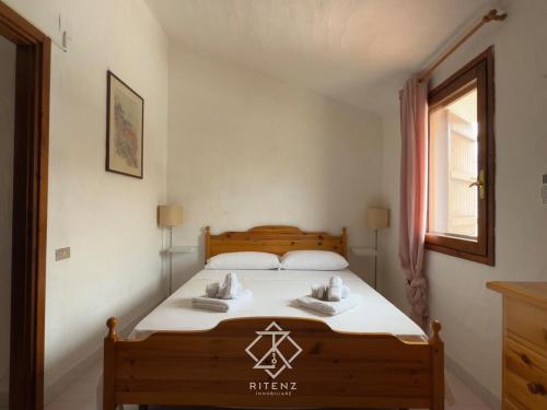 a bedroom with a bed with two towels on it at Domu Camelia - 300 meters from the sea in Porto Ottiolu