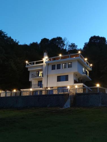 a large white building with lights on top of it at Villa High Point in Pravets
