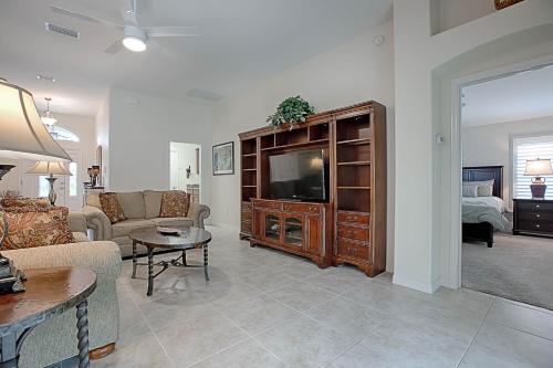 a living room with a couch and a television in it at 1987 Z3a Village of Pennecamp by REMAX Premier in The Villages
