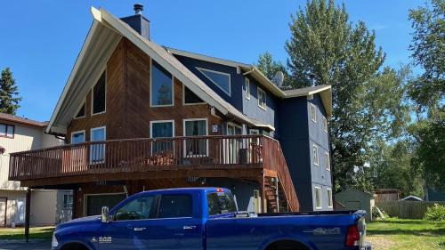 a blue truck parked in front of a house at Dimond Jewel in Anchorage
