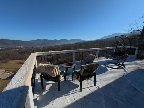 a group of chairs and a table on a balcony at Villa High Point in Pravets
