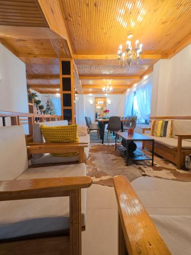 a living room with couches and a chandelier at Villa High Point in Pravets