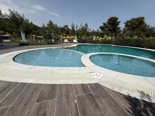 a large swimming pool with a wooden floor at Canyon Villa Göynük Kemer Antalya with Pool in Antalya