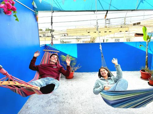 a group of people sitting in hammocks at Raymi House Hostel in Arica