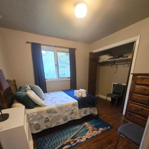 a small bedroom with a bed and a window at Trailhead Room - Near Mendenhall Glacier, Trails, and Conveniences - DISCOUNTS ON TOURS! in Mendenhaven