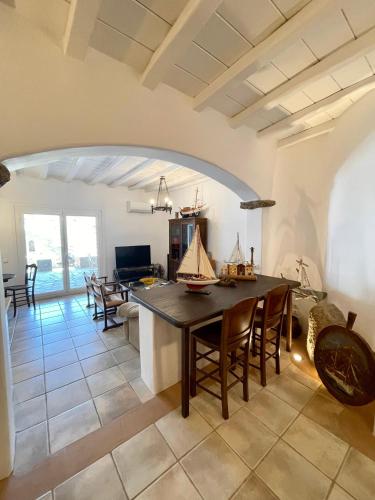 a kitchen and living room with a table and chairs at Agrari Village Apartment Mykonos in Agrari