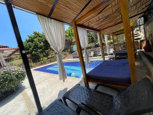a room with a bed and a swimming pool at Casa Campestre Villateresita in Anapoima