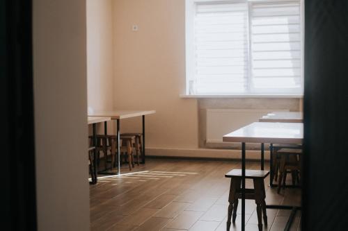 an empty room with tables and chairs and a window at 4ua-хостел in Bratslav