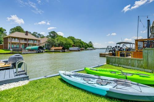 three boats are parked on the grass next to the water at Exquisite Canal-Front Home Access to Lake Conroe! in Montgomery
