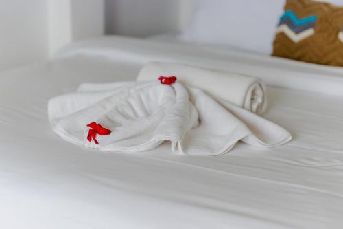 a white towel on top of a bed at Homely Bali at Kayu Aya in Seminyak