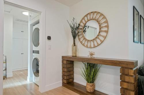 a living room with a console table and a mirror at Lake Balboa Hideaway in Los Angeles