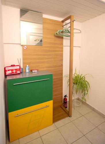 a kitchen with a green and yellow refrigerator in a room at Apartment in Kordel in Kordel