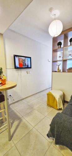 a living room with a tv on the wall at Rent for Days in San Miguel de Tucumán
