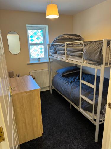 a room with two bunk beds and a desk at Modern cosy sleeps 5 first floor central MD2 in Market Drayton