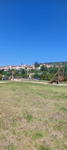 an empty park with a bench in a field at Le pat' toit in Aurec-sur-Loire