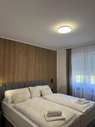 a bedroom with a large bed with towels on it at FeWo Böhmeheide Soltau in Soltau