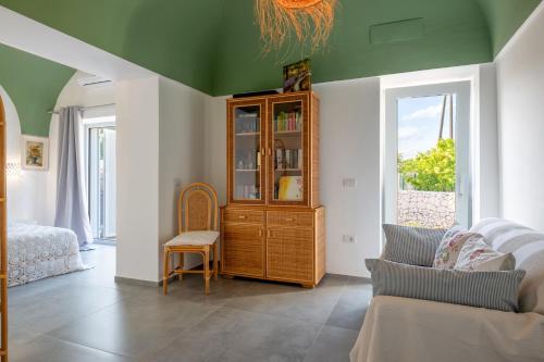 a living room with a green ceiling and a couch at La Casita Ostuni - Authentic Apulian Stay in Ostuni