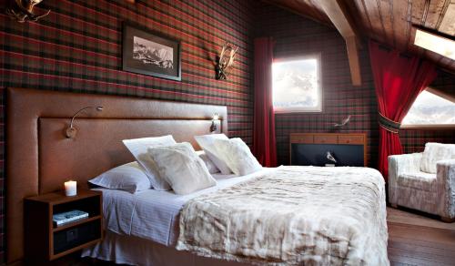 a bedroom with a bed and a red brick wall at Lodge Park in Megève