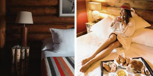 a woman sitting on a bed with a tray of food at Lodge Park in Megève
