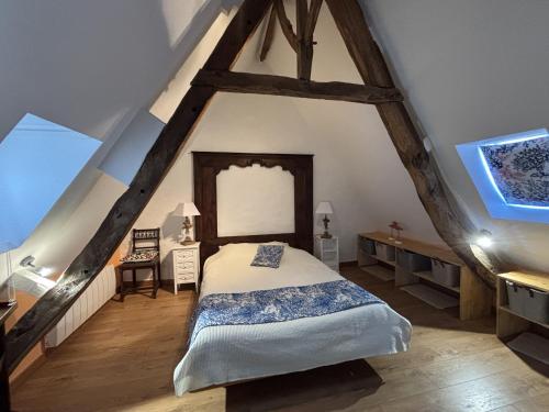 a bedroom with a bed in the attic at BOILLOT, Trebeurden in a quiet area with sea view in Trébeurden