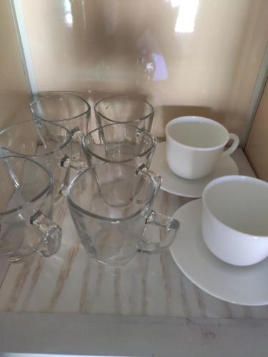 four clear glass bowls and cups on a table at Elegant Apartments & Aquapark - B&B- FREE WI-FI-Sharm El Sheikh in Sharm El Sheikh