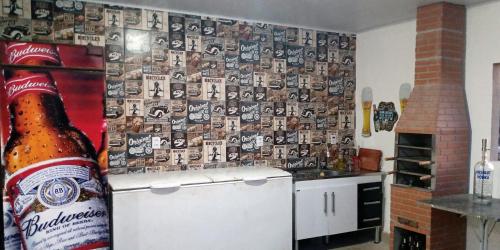a kitchen with a bottle of beer on a refrigerator at Vila Suítes Coliving in Vila Velha