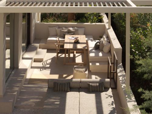 a patio with a couch and a table at Dyo Beach Suites in Rethymno Town