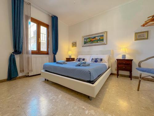 a bedroom with a bed and a table and a window at 49 Sea Rooms - Guesthouse by Host Hero in Stintino