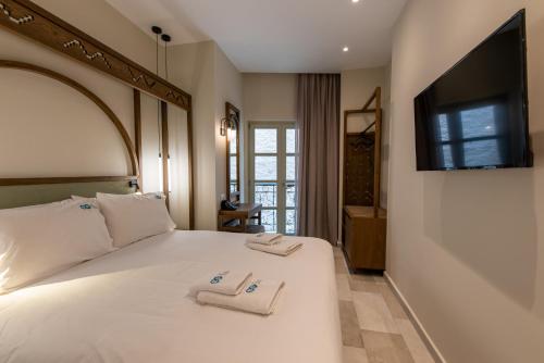 Postel nebo postele na pokoji v ubytování El Greco Hotel