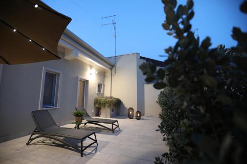 a patio with two chairs and a table at Palazzo Novecento in Cassano delle Murge