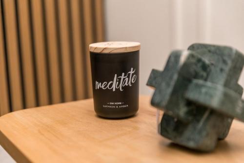a coffee cup sitting on a table next to a statue at Luxurious Home Away From Home in Pickering