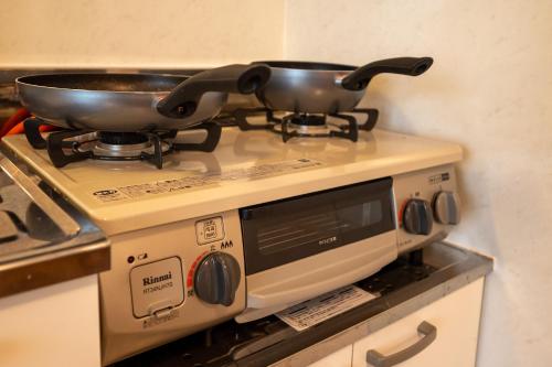 a pot on top of a stove in a kitchen at BREEZE furano 202 in Furano