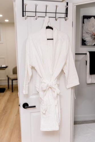 a white robe hanging on a door at Luxurious Home Away From Home in Pickering