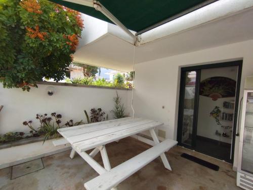 a white bench sitting in a room with a window at Fiore di Loto Rooms in Carini