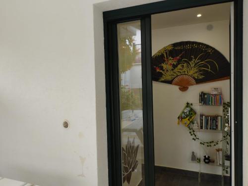 a glass door to a room with a bedroom at Fiore di Loto Rooms in Carini