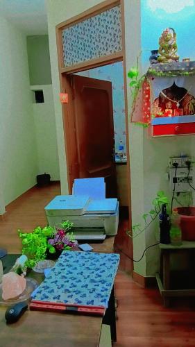 a living room with a table and some boxes at Hotel paris in Mohali