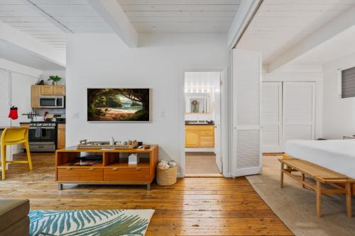 a bedroom with white walls and a bed and a table at Big Island Kona Mansions 110C by Coldwell Banker Island Vacations in Kailua-Kona